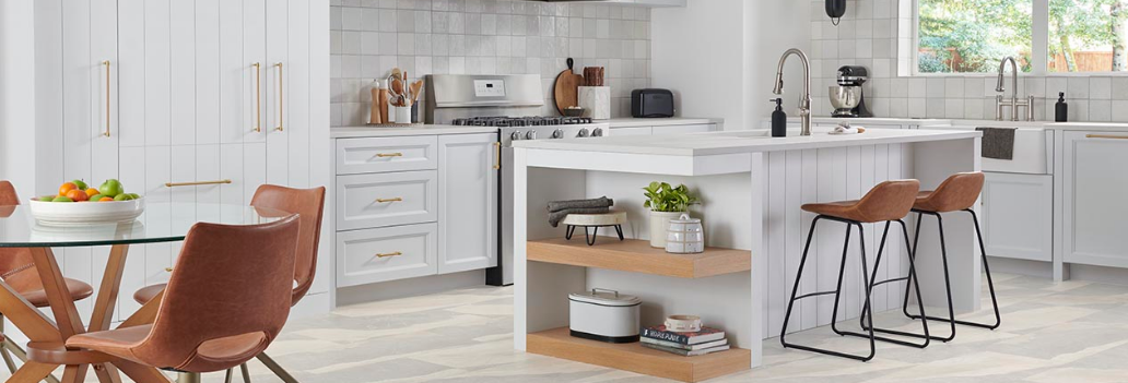 Large, marble look patterned tiles in warm neutrals add texture and style to a bright, sunny kitchen.